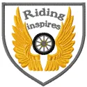 Riding inspires embroidery design featuring intricate stitching of a motorcycle and road elements.