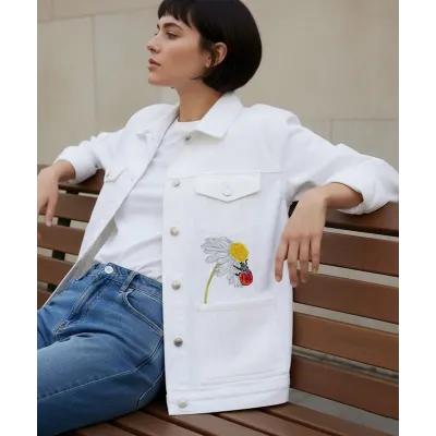 Ladybug on chamomile embroidery design preview, showcasing vibrant colors and detailed stitching.