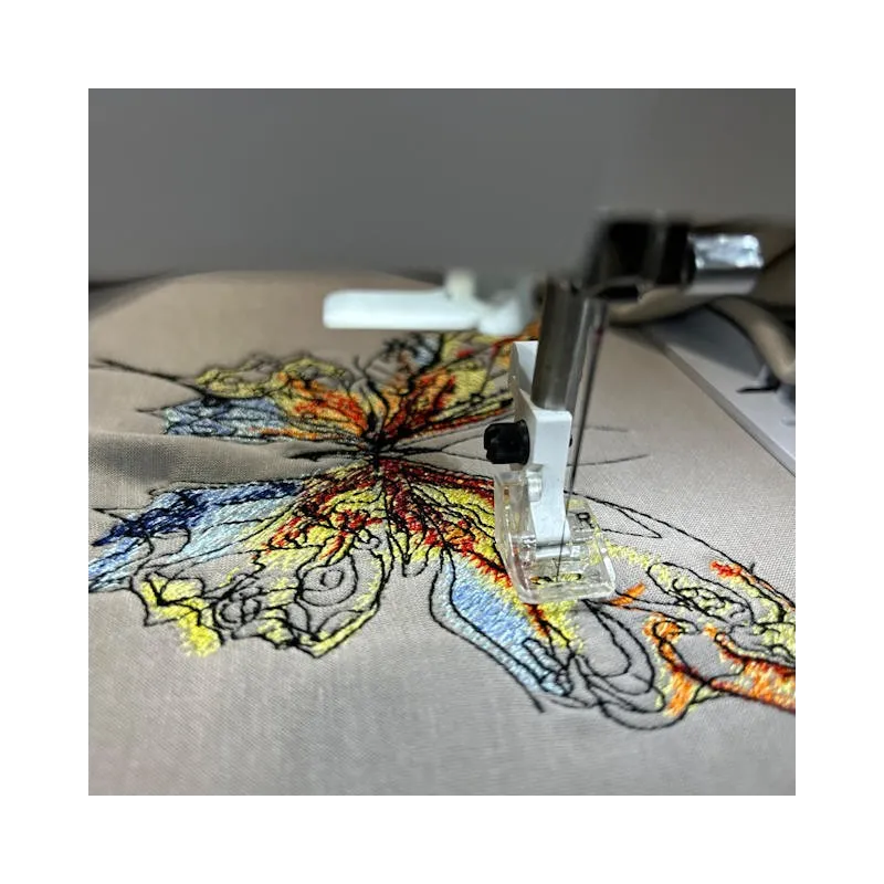 Closeup of the Butterfly 'Let It Be' embroidery design showcasing intricate stitching for various fabric items.