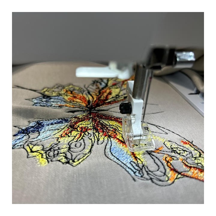 Closeup of the Butterfly 'Let It Be' embroidery design showcasing intricate stitching for various fabric items.