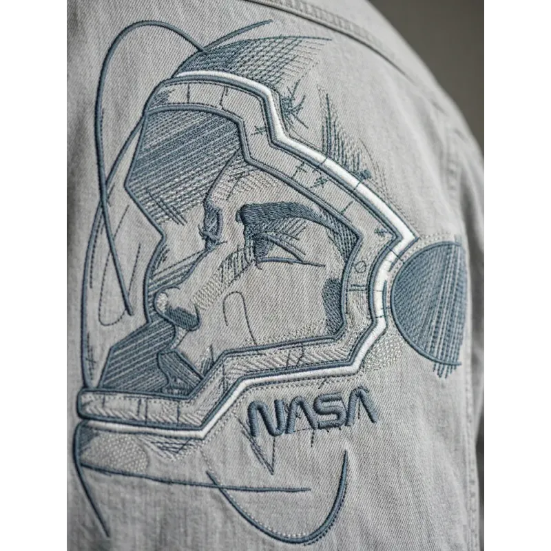Closeup of an astronaut in a helmet embroidery design from the Fantastic World collection.
