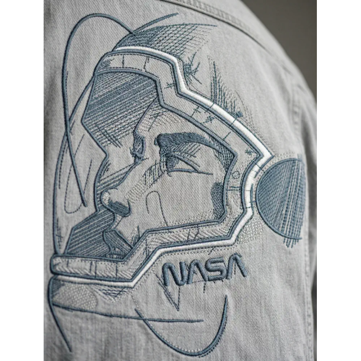 Closeup of an astronaut in a helmet embroidery design from the Fantastic World collection.
