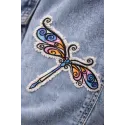 Closeup of a delicate dragonfly embroidery design showcasing intricate details and stitching patterns.