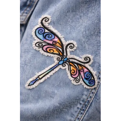 Closeup of a delicate dragonfly embroidery design showcasing intricate details and stitching patterns.