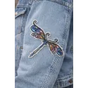 Closeup of a delicate dragonfly embroidery design showcasing intricate stitching patterns for creative projects.