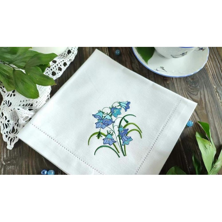 Closeup of a bluebells flowers bouquet embroidery design, showcasing intricate stitching patterns of floral motifs.