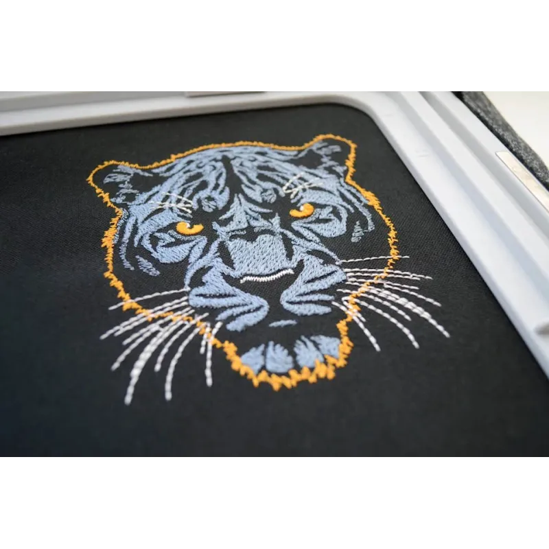 Embroidery design featuring a dark blue panther on a dark background, showcasing intricate stitching patterns.