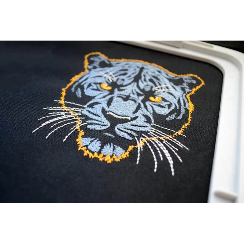 Embroidery design featuring a dark blue panther on a dark background, ideal for jackets and bags.