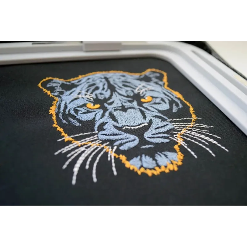 Embroidery design featuring a dark blue panther on a dark background, ideal for creative stitching projects.