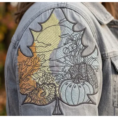 Closeup of an autumn leaf landscape embroidery design, showcasing intricate details for fall-themed stitching projects.