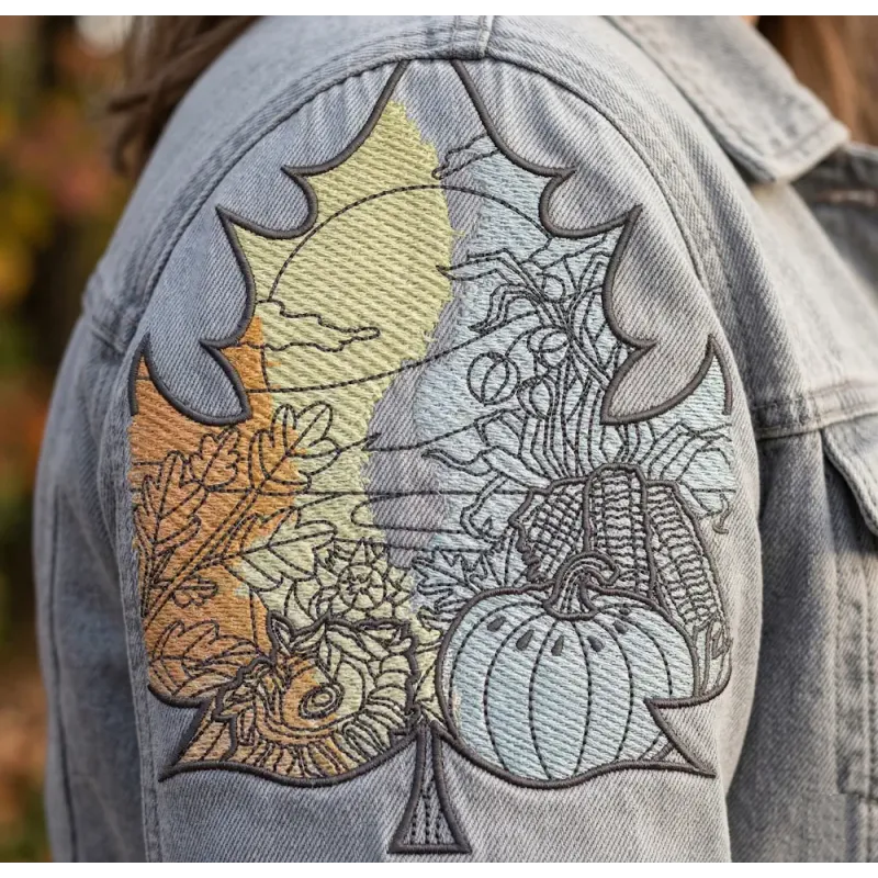 Closeup of an autumn leaf landscape embroidery design, showcasing intricate details for fall-themed stitching projects.