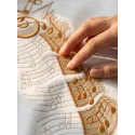 Music giraffe embroidery design mockup showing stitched pattern details