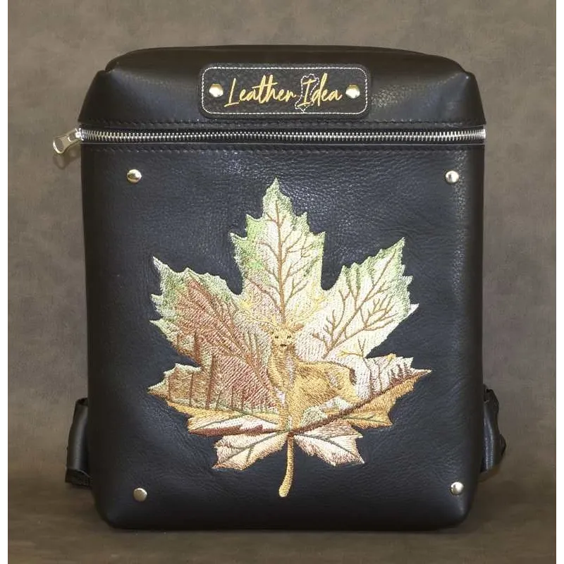 Horned deer on maple leaf embroidery design preview showing woodland animal stitching pattern